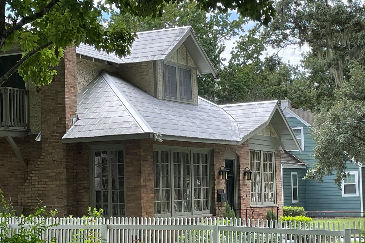 Roof age and older Florida home insurance Silver metal roof on an older brick bungalow-style home in Mount Dora; roof age weighs heavily in older Florida home insurance