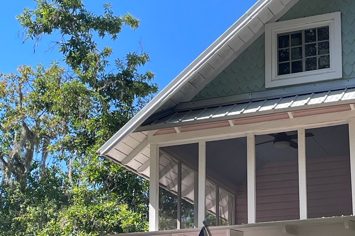 Screened porch on an older Mount Dora home Screened upstairs porch with a ceiling fan under the gable of a pink older home in Mount Dora