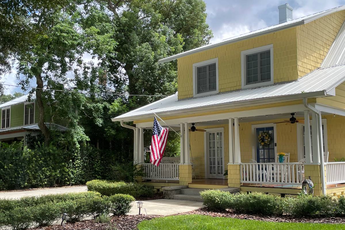 Mowed lawn, trimmed shrubs, and a tidy front porch on a yellow historic bungalow in Mount Dora, the cared-for look that helps when selling an inherited home in Lake County